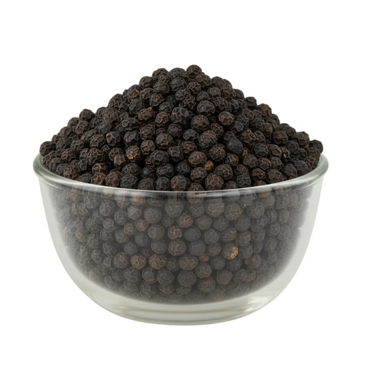 Black peppercorns filling the original glass bowl