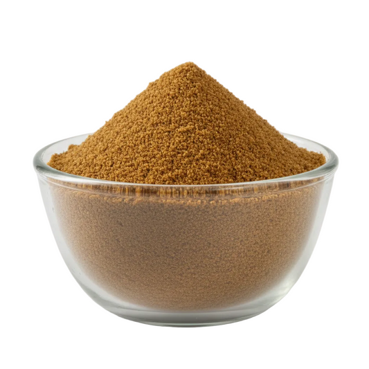 Palm jaggery powder in a glass bowl on white